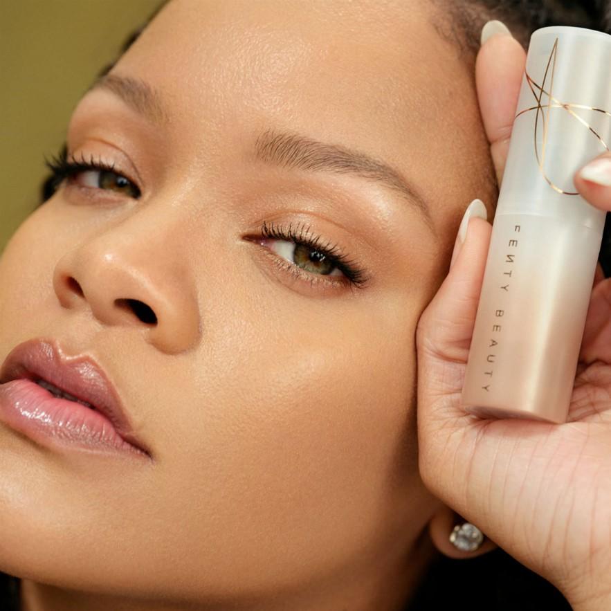 Rihanna, Founder of inclusive beauty brand, Fenty Beauty, holding the Fenty Beauty Eaze Drop Tint Stick